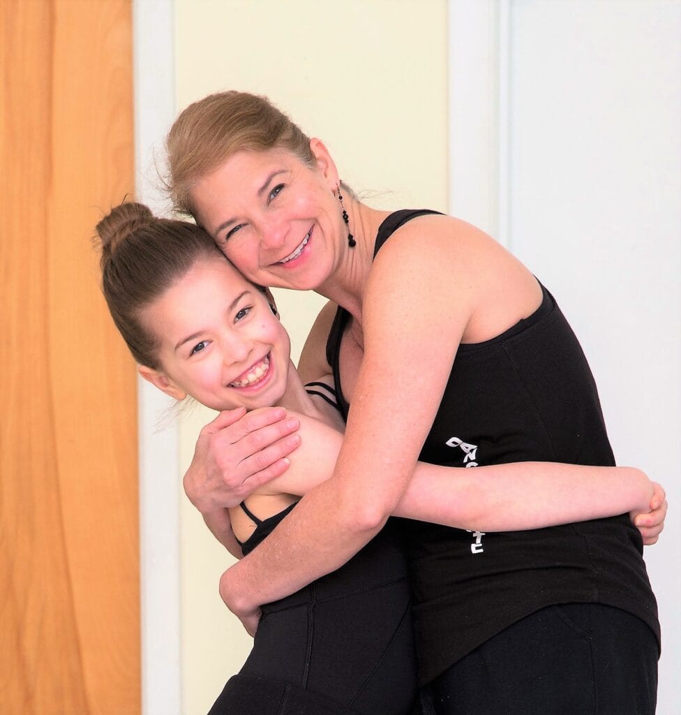 Proud dance teacher embraces happy student